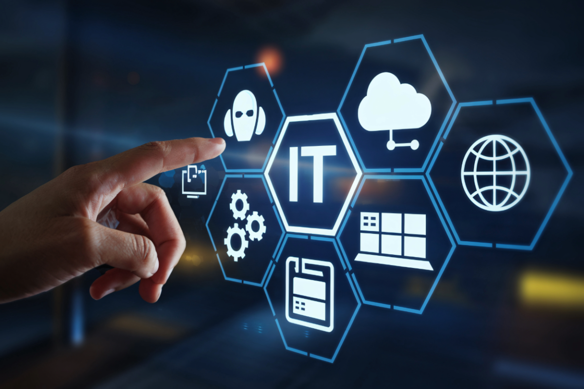 「IT」を中心に、AI、クラウド、ネットワーク、設定などのアイコンが並ぶデジタルインターフェースを指で操作しているイメージ画像。